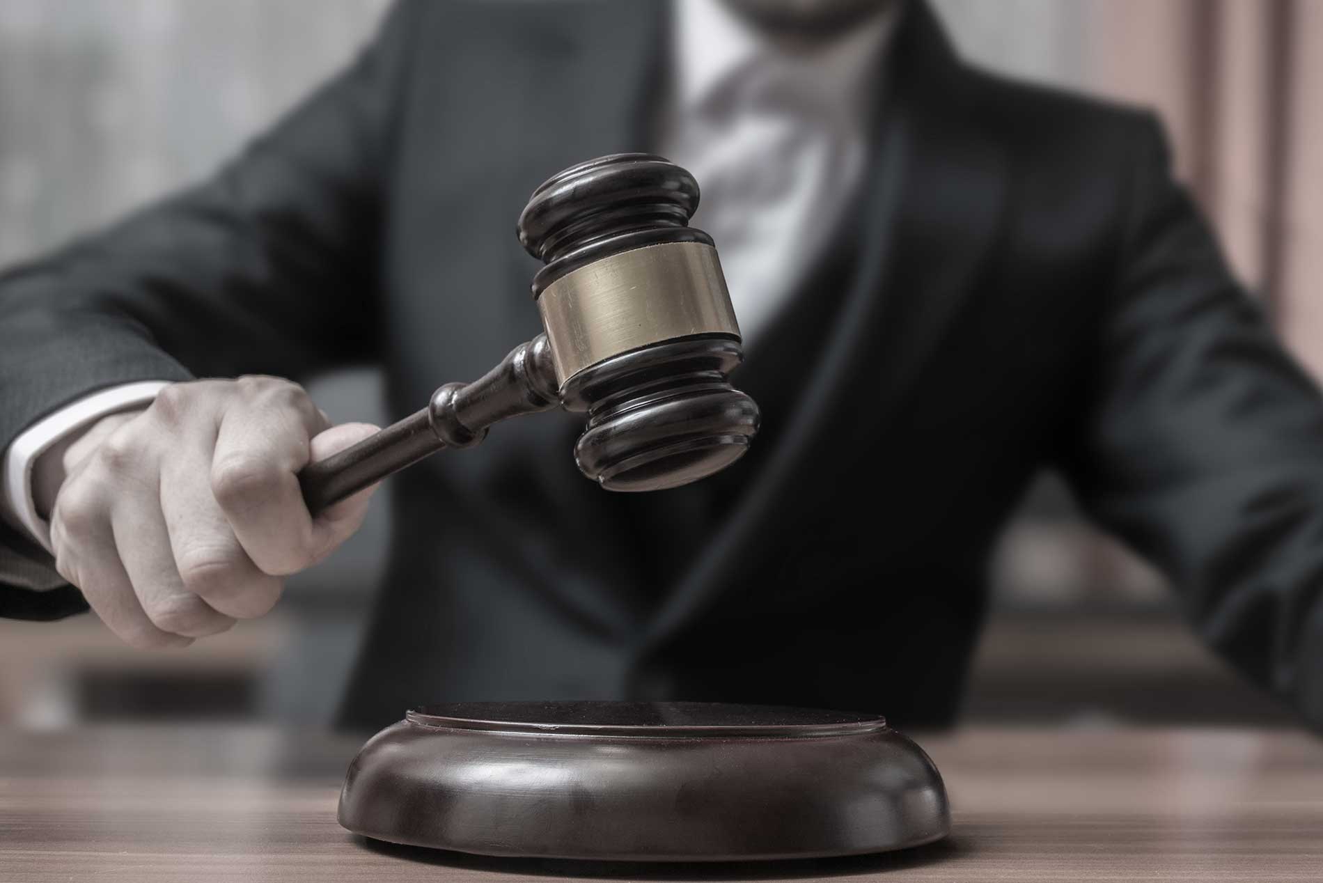 Auctioneer raising a gavel to finalize a bid